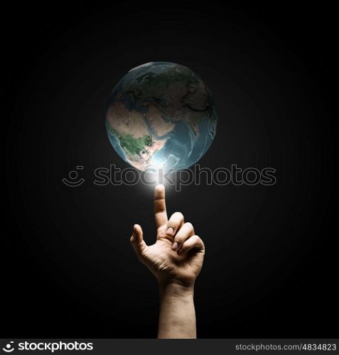 Global connection. Human hand pointing with finger on Earth planet. Elements of this image are furnished by NASA