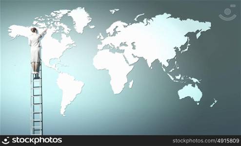 Global interaction. Back view of businesswoman standing on ladder and touching world map