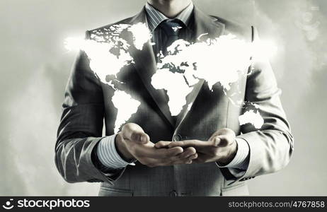 Global interaction. Close up of businessman holding world map in hands