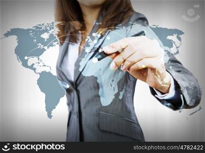 Global interaction. Close up of businesswoman drawing world map with pen
