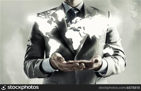 Global interaction concept. Close up of businessman holding world map in hands