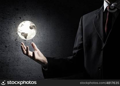 Global media technologies. Man hand holding digital Earth planet representing global technologies concept