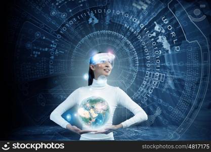 Global media technologies. Young woman holding digital Earth planet in hands. Elements of this image are furnished by NASA