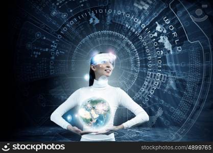 Global media technologies. Young woman holding digital Earth planet in hands. Elements of this image are furnished by NASA