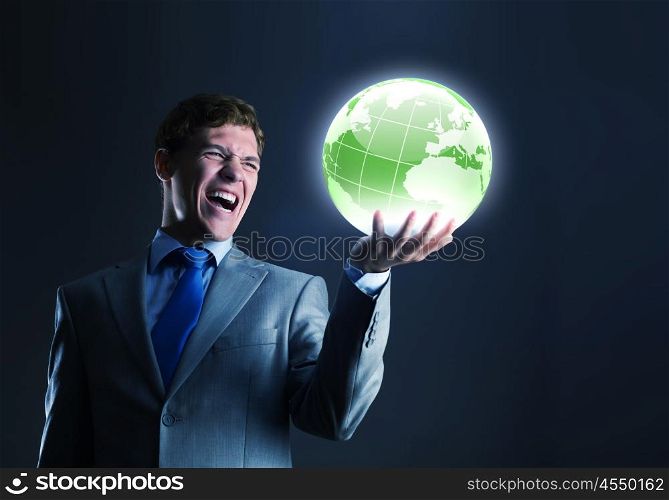 Global media. Young businessman holding digital globe in palm
