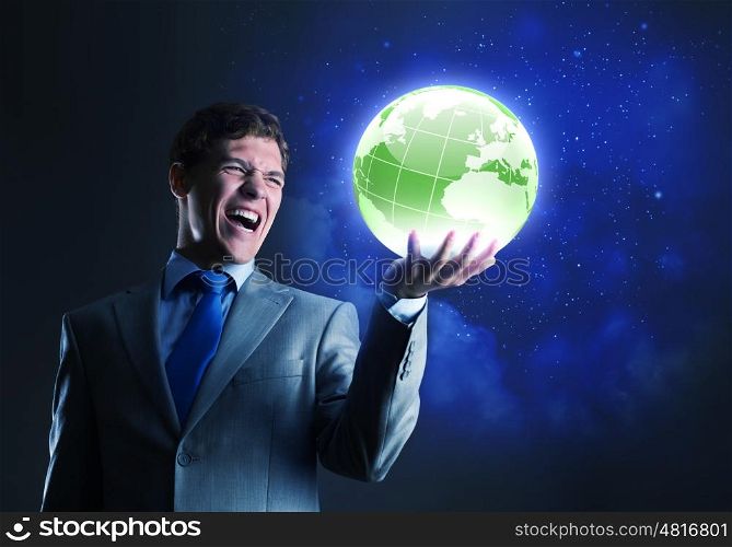 Global media. Young businessman holding digital globe in palm