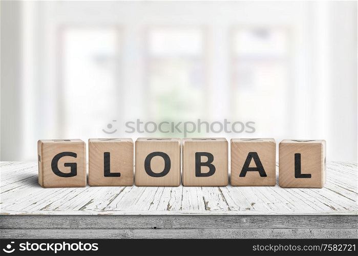 Global sign made of wood in a bright room on a white desk with worn paint