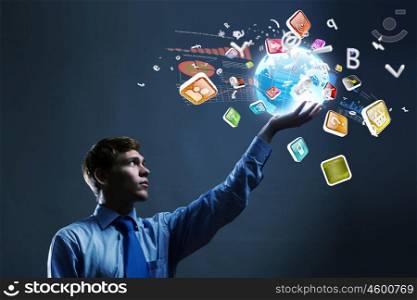 Global technologies. Businessman holding digital Earth planet in hand