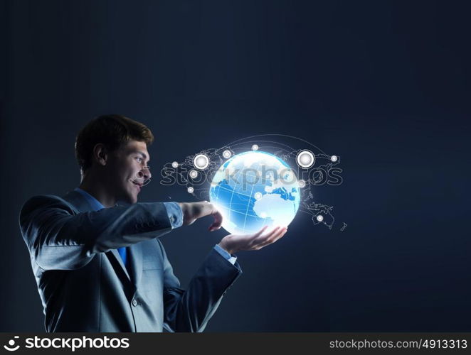 Global technologies. Businessman holding digital Earth planet in hand