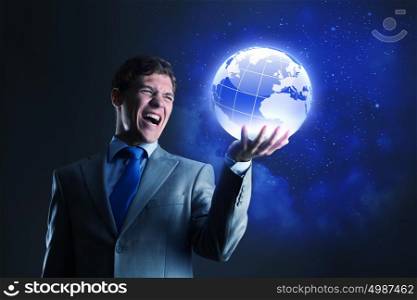 Global technologies. Businessman holding digital Earth planet in hand