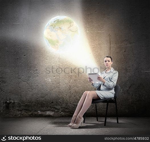 Global technologies. Image of businesswoman sitting on chair with tablet pc in hands