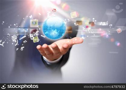 Global technologies. Image of globe on palm of businessman. Media technologies