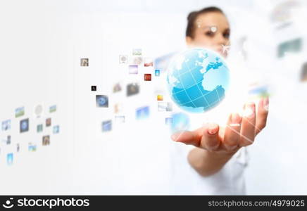 Global technologies. Image of globe on palm of businesswoman. Media technologies