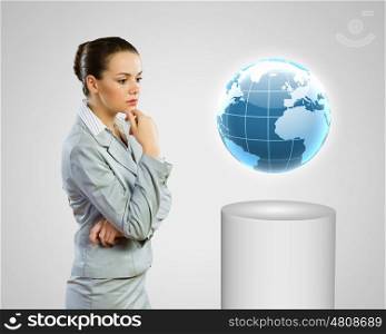 Global technologies. Image of thoughtful businesswoman looking at globe