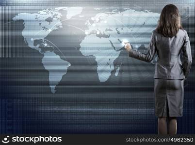 Global technologies. Rear view of businesswoman pointing on media screen