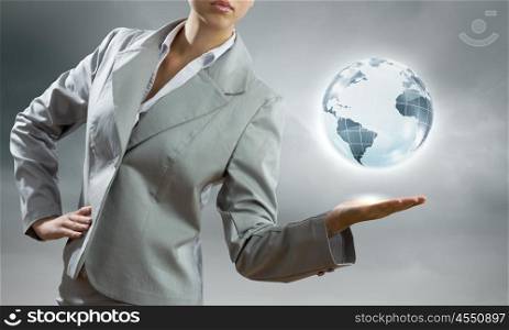 Global technologies. Young businesswoman holding Earth planet in palm