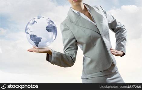 Global technologies. Young businesswoman holding Earth planet in palm