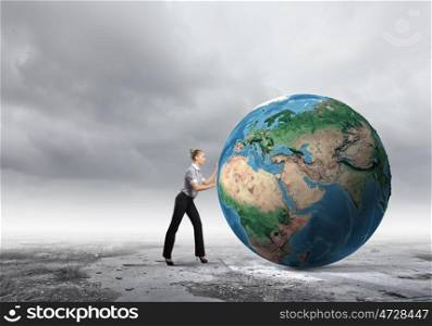 Global technologies. Young businesswoman pushing Earth planet. Elements of this image are furnished by NASA