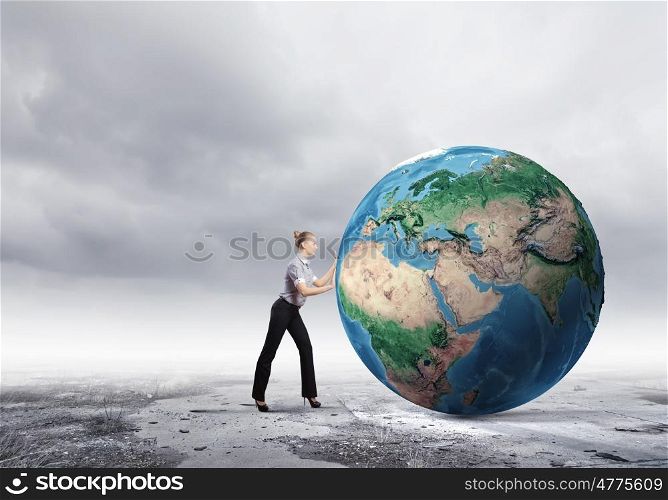 Global technologies. Young businesswoman pushing Earth planet. Elements of this image are furnished by NASA