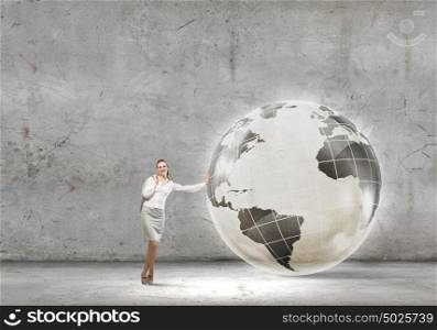 Global technologies. Young successful businesswoman leaning on Earth planet