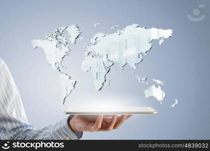 Global technology concept. Businessman hands holding tablet with world map on screen