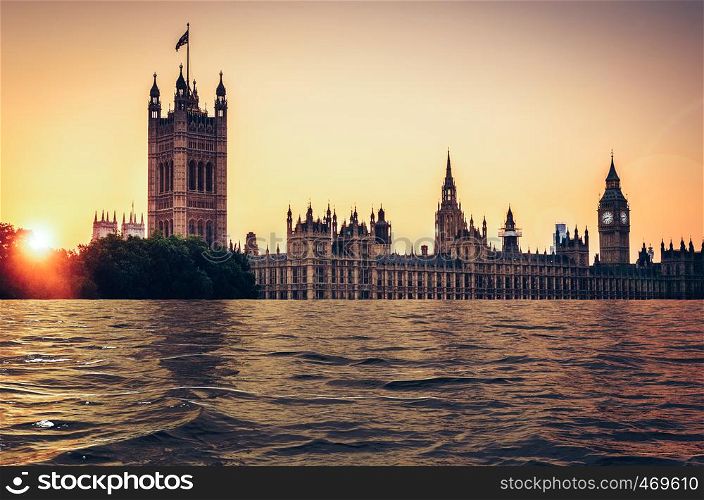 Global warming, climate change, melting ice caps futuristic concept. Digital manipulation of flooded Houses of parliament at sunset, London, UK