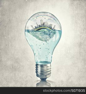 Global warming concept. Glass light bulb with water and cityscape inside