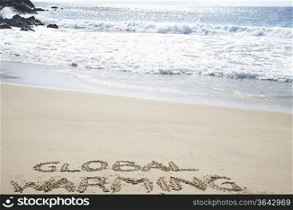 Global warming text written in beach, elevated view