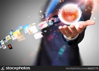 Globalization concept. Person holding illustration of globe in hand. Media technologies