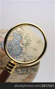 Globe and Magnifying glass