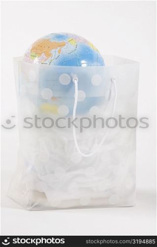 Globe in a transparent shopping bag