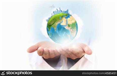 Globe in hands. Close up of human hands holding Earth planet. Elements of this image are furnished by NASA