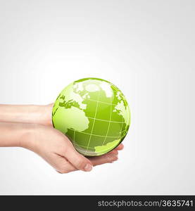 Globe in human hand against blue sky. Environmental protection concept. Elements of this image furnished by NASA