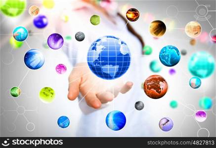 Globe in palm. Items and icons on human hand. Global technologies