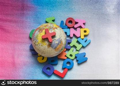 Globe model on colorful letters on a colorful background