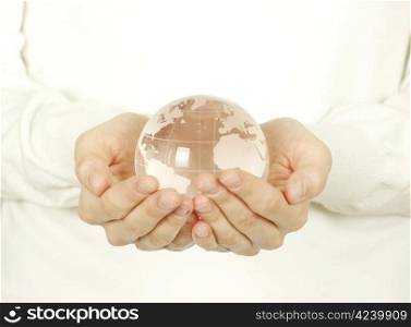 globe on the human hand on white