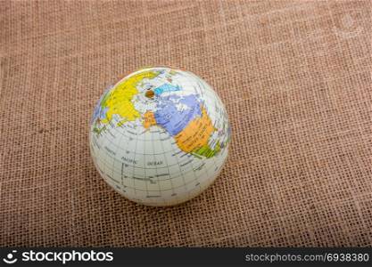 Globe placed on a brown fabric background