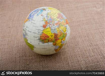 Globe placed on a brown fabric background