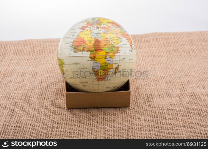 Globe with a telephone booth on canvas background