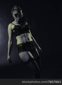 Gloomy atmosphere, sexy woman wearing a gas mask and lingerie - split toning, black and white image, intentional film grain added