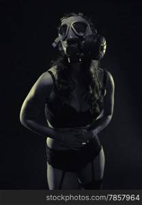 Gloomy atmosphere, sexy woman wearing a gas mask and lingerie - split toning, black and white image, intentional film grain added