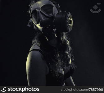 Gloomy atmosphere, sexy woman wearing a gas mask and lingerie - split toning, black and white image, intentional film grain added