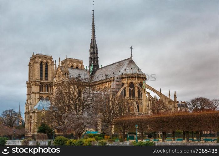 Gloomy cityscape with southern facade of Cathedral of Notre Dame de Paris in the winter day, France