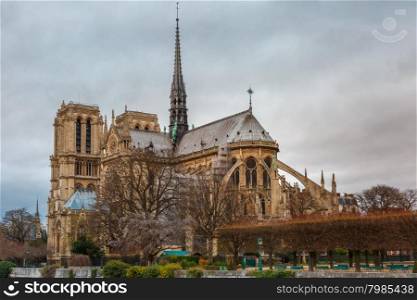Gloomy cityscape with southern facade of Cathedral of Notre Dame de Paris in the winter day, France