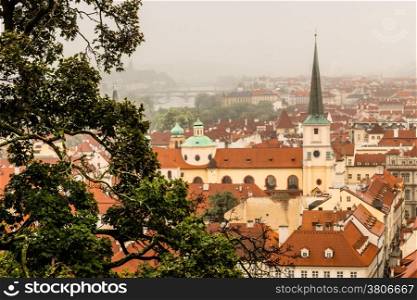 Gloomy day of rain and fog over the red roofs of Prague in the Czech Republic in Central Europe.