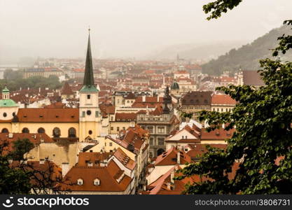 Gloomy day of rain and fog over the red roofs of Prague in the Czech Republic in Central Europe.