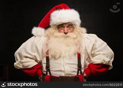 Gloomy Santa Claus portrait against dark background