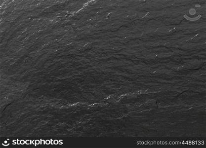Glossy black slate background or texture.. Glossy black slate background or texture