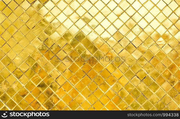 Glossy Gold mosaic tile wall, texture background.