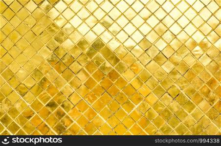 Glossy Gold mosaic tile wall, texture background.
